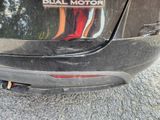 a close up of a black car with a dual motor emblem on it