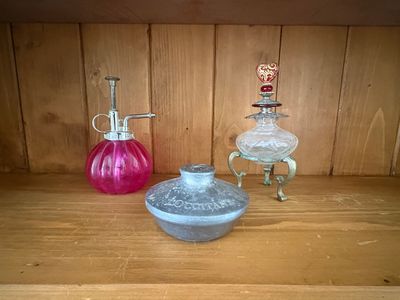 two vases sitting on a wooden shelf next to each other