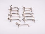 six antique silver plated dachshunds on a white background