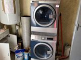 a stack of washers and dryers in a room