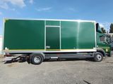 a large green truck that is parked in a lot