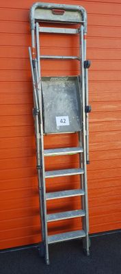 a ladder leaning against a wall with a sign on it
