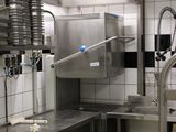 a large kitchen with stainless steel appliances and a sink
