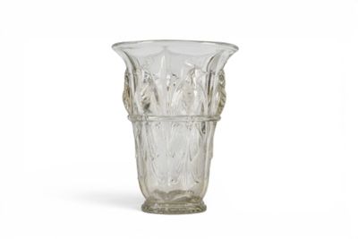 a glass vase that is sitting on a white surface