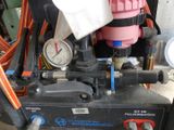 a picture of a machine with a pressure gauge and a hose