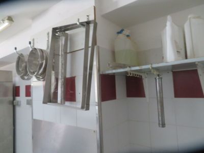 a picture of a kitchen with a lot of pots and pans hanging on the wall