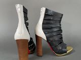 pair of black and white high heeled shoes with wooden heel