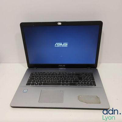 a laptop computer sitting on a table with a blue screen