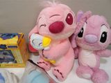 two stuffed animals sitting next to each other on a table
