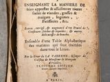 an old book with writing on it sitting on top of a table
