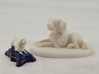 figurine of a dog and a cat sitting on a pillow