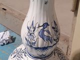 a blue and white vase sitting on a blue table