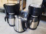 three coffee makers sitting on the kitchen floor