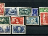 several different colored stamps on a black surface with a picture of a man