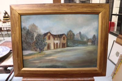 a picture of a painting of a house on a table