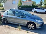 a small silver car parked on the side of the road