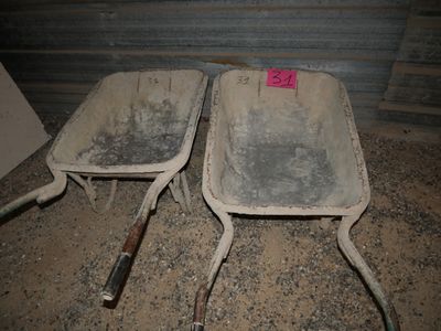 two dirty chairs sitting next to each other in the dirt