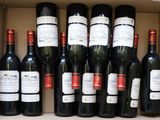 many bottles of wine sitting in a box together