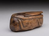 an old wooden box sitting on top of a white surface