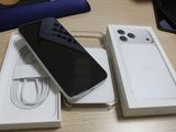 two iphones sitting on a table next to each other