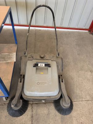 an image of a push mower in a garage