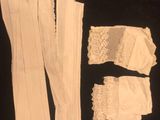 white lace garters and garters laid out on a black surface