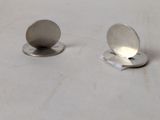 a pair of earrings that are sitting on a table