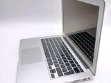 a white laptop computer sitting on a white surface
