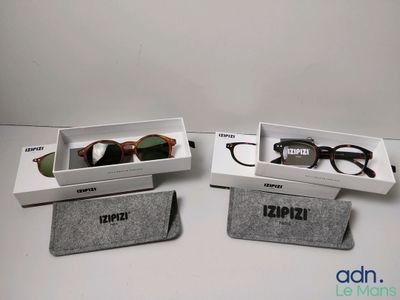 two pairs of glasses are sitting in a box on a table