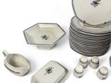 a lot of plates and bowls that are sitting on a table
