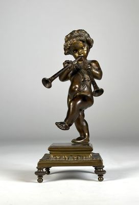 une figurine antique en bronze représentant un garçon jouant de la trompette