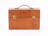 brown leather briefcase with brass handles on a white background