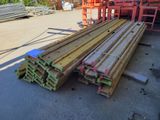 several pieces of wood are stacked on top of each other in a warehouse