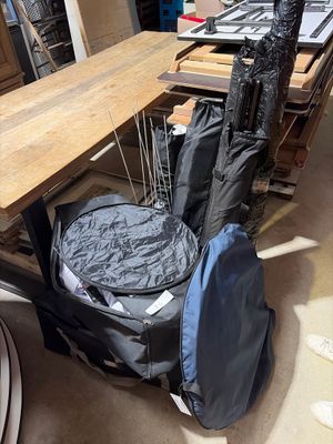 a table with a guitar case on it and a bag on the table