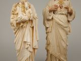 two statues of jesus and a woman holding a rosary