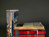 many books stacked on top of each other on a table