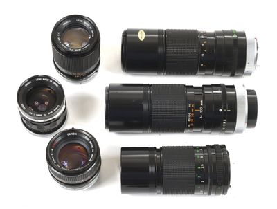 four different lens lenses are lined up on a white surface