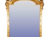 an antique gold framed mirror with a blue glass in the middle