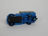 a blue toy truck on a white surface