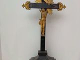 a statue of jesus on a cross on a marble table