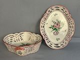 two plates and a bowl sitting on a table