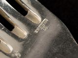 a close up of a knife and fork on a table