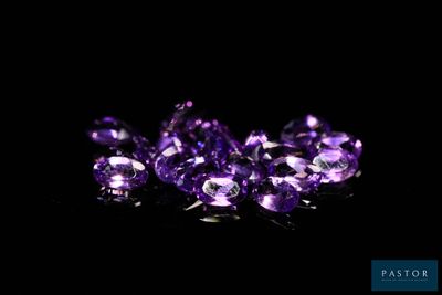 a group of purple gems on a black background