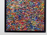 an abstract painting of multicolored paint on a white wall