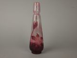 a glass vase with a pink flower inside of it