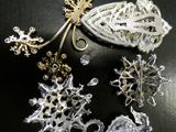 a close up of a brooch and other brooches on a table