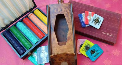 de nombreux jetons de poker de différentes couleurs dans un coffret en bois