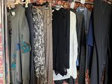 a lot of clothes hanging on a rack in a room