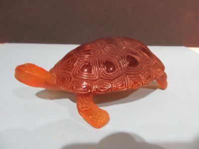 an orange turtle that is sitting on a table