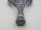 a tennis racket wrapped in plastic on a table